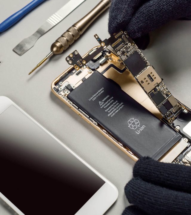 technician-repairing-broken-smartphone-desk